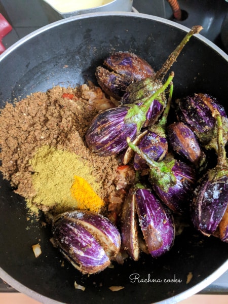 Wet and dry masala paste along with aubergines in a wok