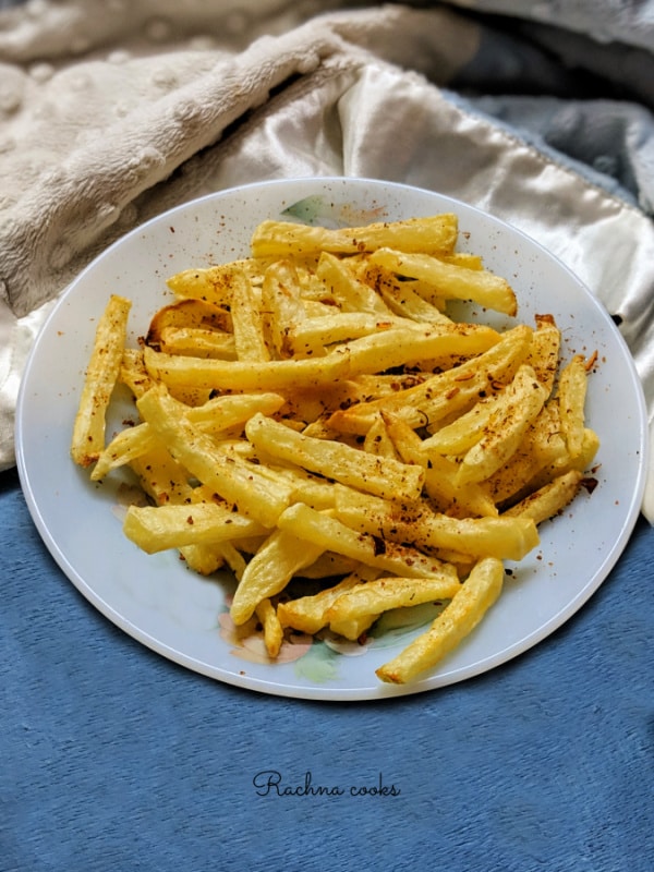 Air fried french fries served on a white plate.