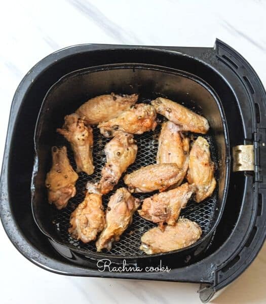 air fryer Buffalo chicken wings after air frying in basket